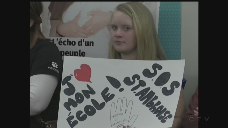 A student holds a sign in support of St. Ambroise remaining open on Monday, Feb. 13, 2017. (CTV Windsor)