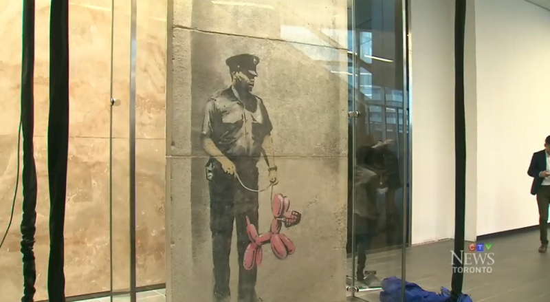 'Police Guard Pink Balloon Dog,' was created by graffiti artist Banksy in Toronto in 2010. 