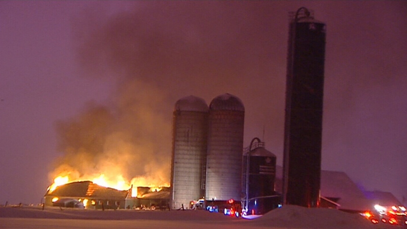 Flames are seen tearing through a barn at the Scullion Farm on Greber Boulevard in Gatineau in the early hours of Wednesday, Feb. 15, 2017.