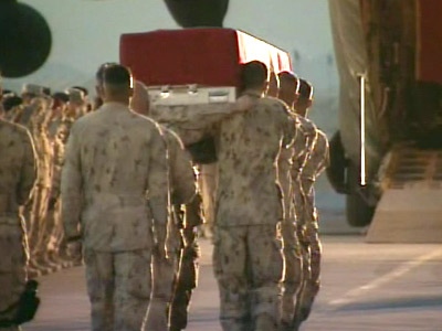 Soldiers carry the casket of Trooper Marc Diab onto an awaiting plane during a ramp ceremony at Kandahar Airfield in Afghanistan on Monday, March 9, 2009.