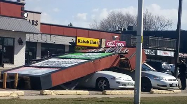 Wind knocks sign onto cars in Chatham.