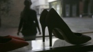 A person looks at high heels on display at the Pretty Small Shoes store in Bloomsbury, London on Monday, March 6, 2017. (AP / Tim Ireland)