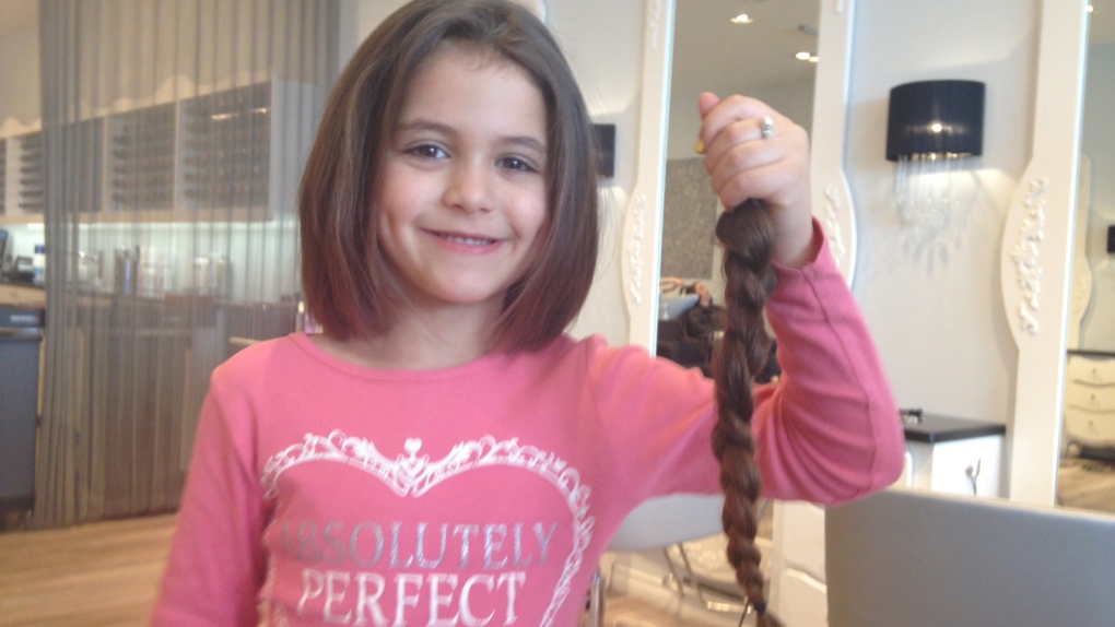 6-year-old girl gets first haircut to help cancer patient | CTV News