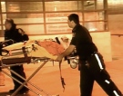 Paramedics wheel a Guvernment shooting victim into hospital on Saturday, March 14, 2009..