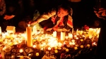 People light candles at a vigil for the victims of Wednesday's attack, at Trafalgar Square in London, Thursday, March 23, 2017. (AP Photo/Matt Dunham)