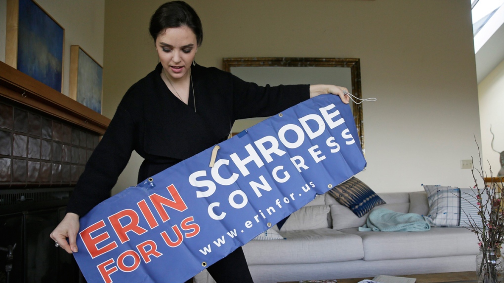 Erin Schrode unfurls a campaign banner