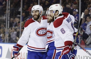 Montreal Canadiens' Dwight King, left, Shea Weber, right, and Torrey Mitchell celebrate a goal by Mitchell during the first period April 18, 2017, in New York. (AP Photo/Frank Franklin II)