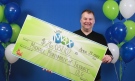 Mike Montminy of Tilbury collects his $26-million cheque in Toronto. (Courtesy OLG)