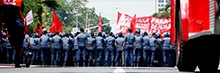 Riot police stand in line