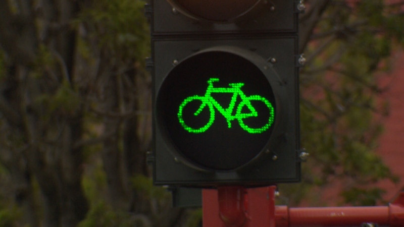 A green bicycle light informs cyclists that they can turn in one of several new changes to Pandora Street on day one of the city's new protected bike lanes. May 1, 2017. (CTV Vancouver Island)