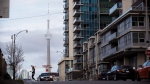 The CN Tower can be seen behind condo's in Toronto's Liberty Village community in Toronto, Ontario on Tuesday, April 25, 2017. (THE CANADIAN PRESS/Cole Burston)