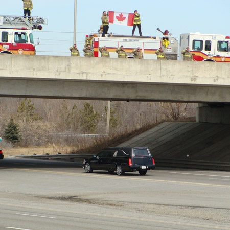 Members of Fire Station 44 in Barrhaven salute returning falling soldier Cpl. Kenneth Chad O'Quinn on the Fallowfield-Strandherd Bridge just outside of Barrhaven, Wednesday, March 25, 2009. Viewer photo submitted by: Kellie Jennifer Adams