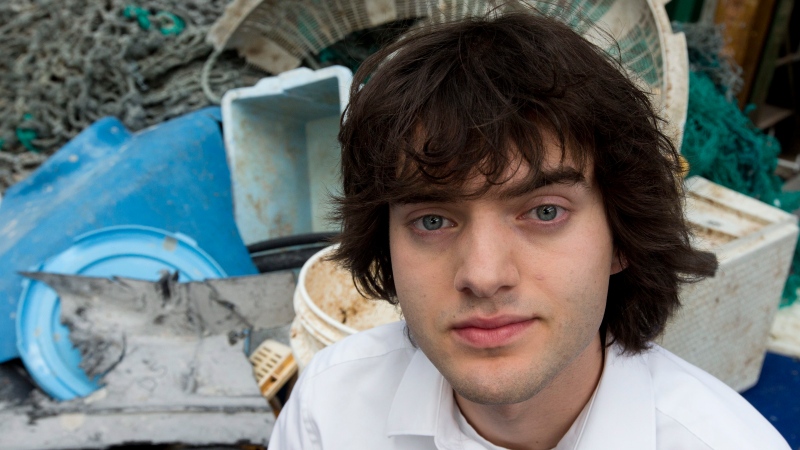 Dutch university dropout Bojan Slat, who founded The Ocean Cleanup, poses for a portrait next to a pile of plastic garbage prior to a press presentation in Utrecht, Netherlands, Thursday, May 11, 2017. (Peter Dejong/AP Photo)
