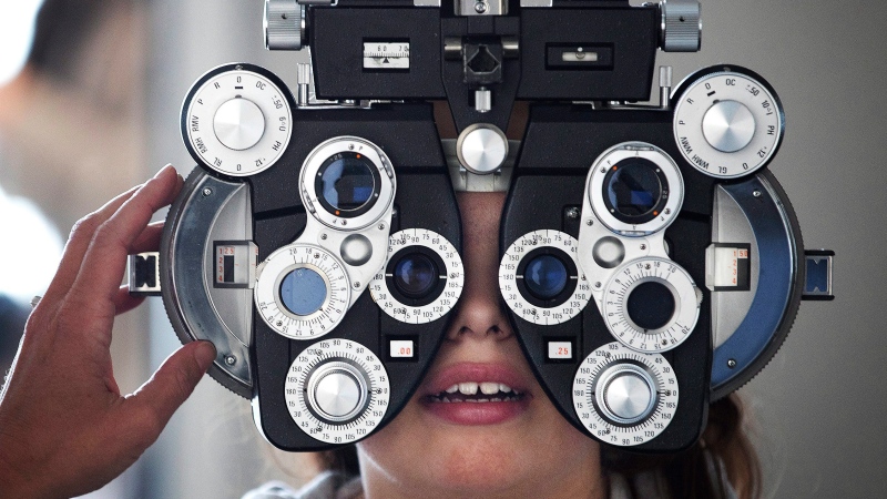 In this Tuesday, March 21, 2017, photo, Optometrist Linda Morgan uses a phoropter to help determine a prescription for Liberty Elementary School student Brooklyn Richotte during a vision screening in Omaha, Neb. (Megan Farmer/Omaha World-Herald via AP)