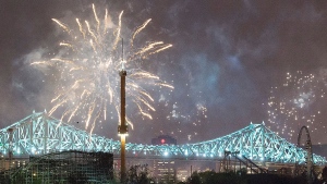 Fireworks explode over an illuminated Jacques Cartier Bridge to celebrate the city's 375th birthday Wednesday, May 17, 2017, in Montreal. (Graham Hughes/The Canadian Press via AP)
