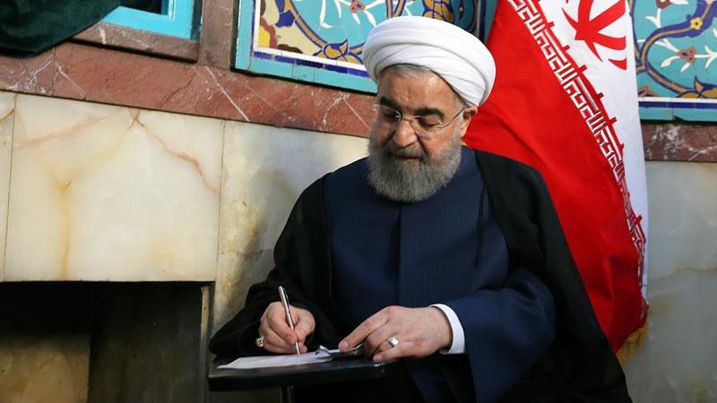 Iranian President Hassan Rouhani fills in ballot