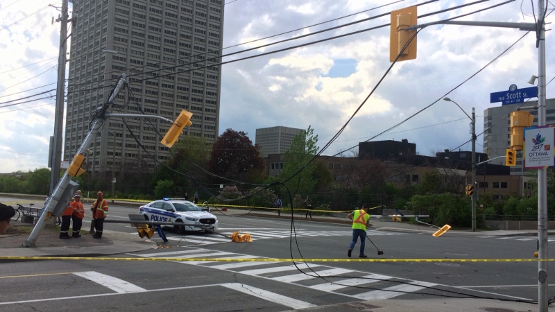 Power lines are seen draping over the roadway after a truck collided into a street pole at the intersection of Scott St. and Parkdale Ave. in Ottawa on May 23, 2017. (Zane Burtnyk/)