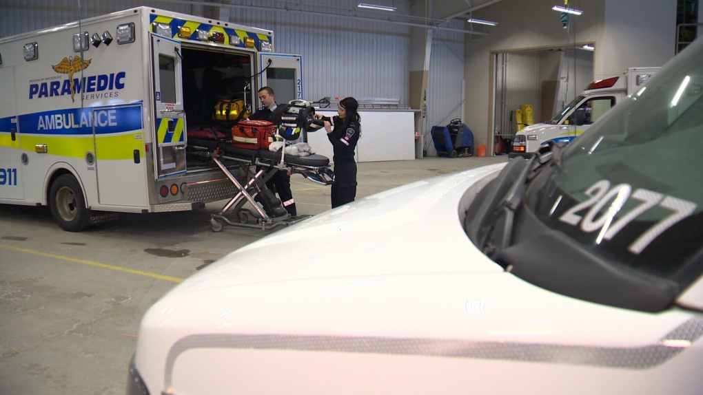 Paramedics load an ambulance