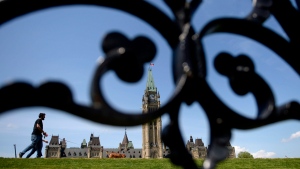 People walk on Parliament Hill in Ottawa on Tuesday, May 23, 2017. THE CANADIAN PRESS/Justin Tang