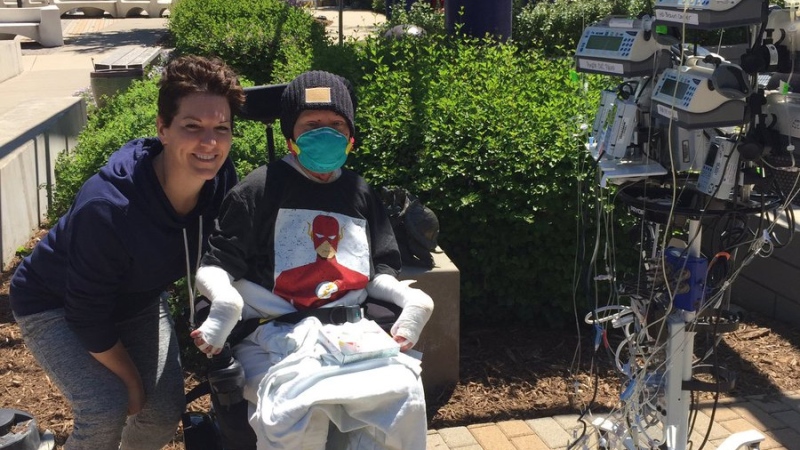 Jonathan Pitre enjoying fresh air outside with his mother Tina Boileau. (Tina Boileau/Facebook)
