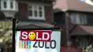 A sold sign is shown in front of west-end Toronto homes Sunday, May 14, 2017. (Graeme Roy/The Canadian Press)