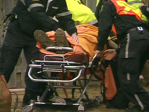 Firefighters and paramedics remove a 32-year-old man from a collapsed trench in North York on Monday, March 30, 2009.