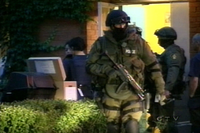 Heavily armed OPP officers conduct the early morning raid in a region of North York on Wednesday, June 13, 2007.