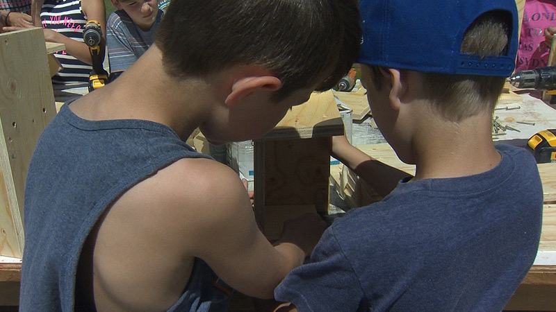 Talon Hynes (L) and Tray Saxton (R) look over some of the materials for the Free Little Library.