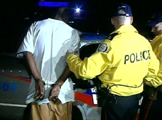 Toronto police make an arrest during the early morning operation, Wednesday, April 1, 2009.