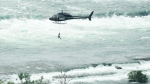 Erendira Wallenda dangles from a helicopter performing a stunt over the Niagara Falls in Niagara Falls, Ont., on Thursday, June 15, 2017. Wallenda performed a series of movements while on a hoop suspended from the helicopter, including hanging from her teeth, her toes and her knees.THE CANADIAN PRESS/Nathan Denette