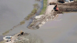The breach in the dike at the hoop and holler bend is seen along the Assiniboine River outside of Portage La Prairie, Man, Saturday, May 14, 2011. (THE CANADIAN PRESS / Jonathan Hayward)
