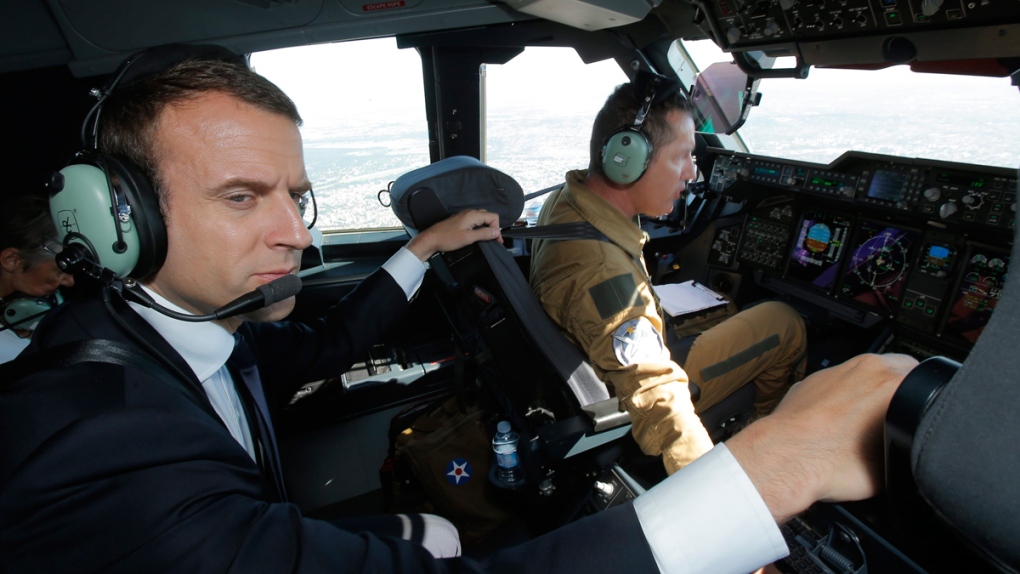 French President Emmanuel Macron in an Airbus A400