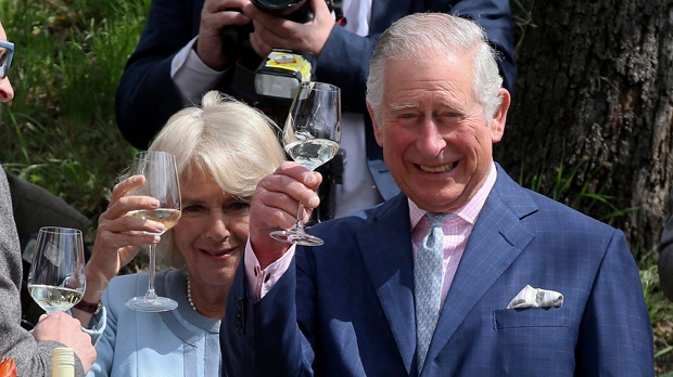 Camilla the Duchess of Cornwall and Britain's Prince Charles, from left, toast as they taste wines at a wine tavern in Vienna, Austria, Thursday, April 6, 2017. (AP Photo/Ronald Zak)