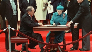 Queen Elizabeth II signs Canada's constitutional proclamation in Ottawa on April 17, 1982 as Prime Minister Pierre Trudeau looks on. (CP PHOTO/Ron Poling)