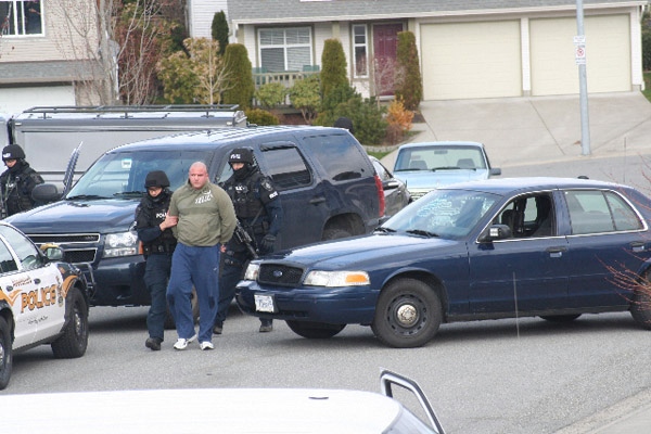 Heavily armed police arrest Jamie Bacon, who police say is a notorious gang member, outside his Abbotsford, B.C., home early morning on Friday, April 3, 2009 (special to ctvbc.ca)