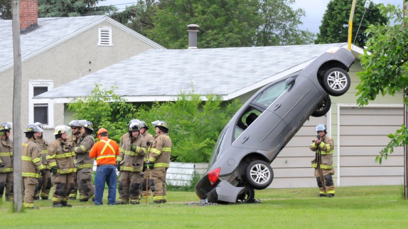 A car sits hung up on a guide wire in Nipawin, Sask., on Thursday, June 22, 2017. (Susan McNeil/Nipawin Journal)