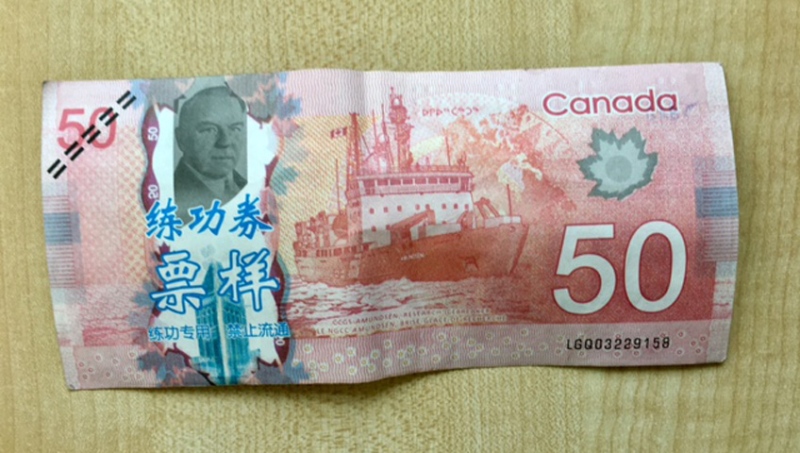 Saskatchewan RCMP are warning businesses and residents to keep an eye out for counterfeit bills, which contain blue Chinese characters and feel like paper instead of plastic. (supplied)