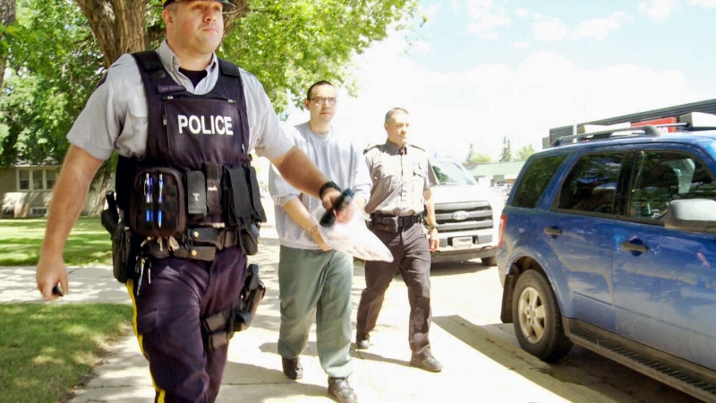 Steven Lewis, centre, is escorted out of Melfort Provincial Court on Wednesday, June 28, 2017, after pleading guilty to second-degree murder in his ex-wife's death. He was sentenced to life in prison with no chance of parole for 22 years after entering the plea. 