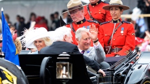 Camilla, Duchess of Cornwall, and Prince Charles ride in a carriage during Canada 150 celebrations in Ottawa on Saturday, July 1, 2017. (Adrian Wyld/THE CANADIAN PRESS)