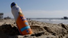 A bottle of in Banana Boat sunscreen is placed in the sand near the Newport Beach pier in Newport Beach Calif., Friday, Oct. 19, 2012. (Chris Carlson/AP Photo) 