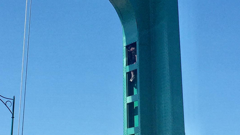 Photos posted to social media appear to show a man climbing on one of the columns on the Lions Gate Bridge. (Instagram/eyoalha)
