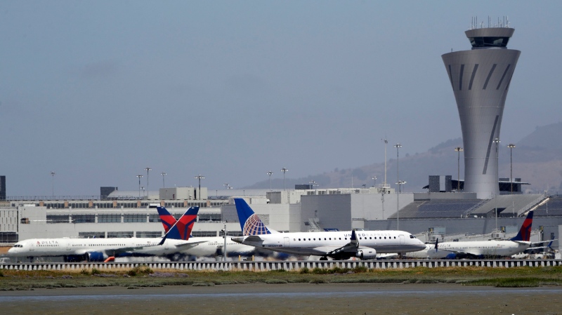 Departing and parked aircraft intersect at San Francisco International Airport, Tuesday, July 11, 2017, in San Francisco. (AP Photo/Marcio Jose Sanchez)