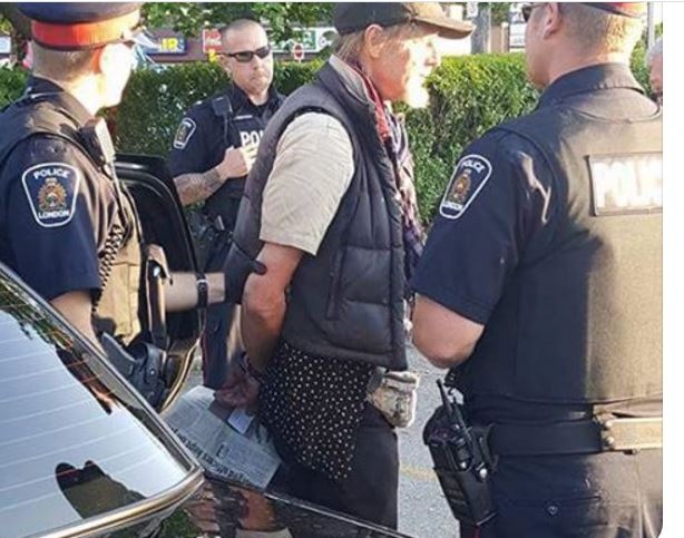 Sunny James, who has been camped out at Huron and Highbury, is seen in handcuffs on Friday, July 14, 2017 after his possessions were removed.
(Facebook / Effy Bailey)