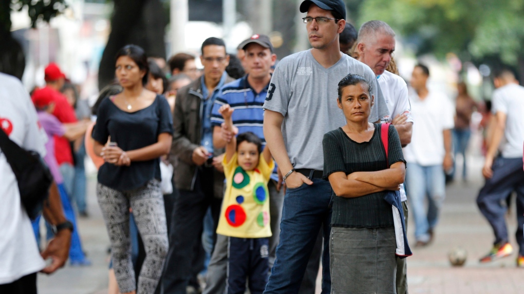 Venezuelan line up outside polling statio