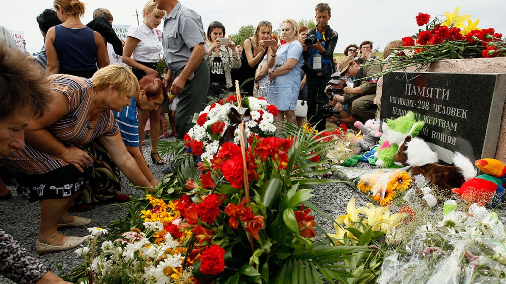 Local residents lay flowers at MH17 memorial