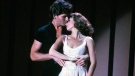 Patrick Swayze, portraying Johnny Castle, and Jennifer Grey, portraying Baby Houseman, in a scene from the film, 'Dirty Dancing.' (Lionsgate Home Entertainment / AP)
