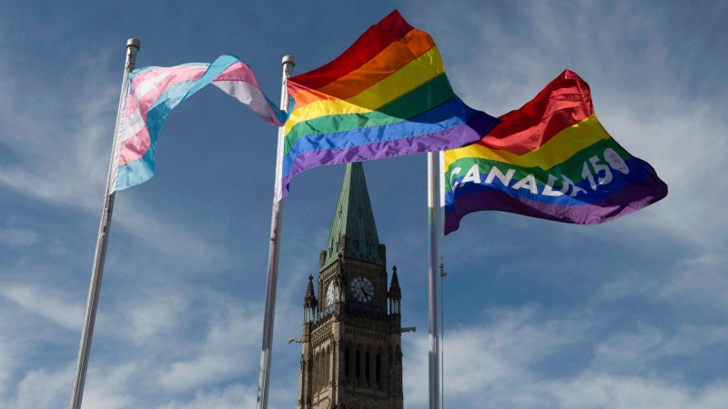The pride and transgender flags fly on Parliament Hill following a ceremony with Prime Minister Justin Trudeau in Ottawa, Wednesday June 14, 2017. THE CANADIAN PRESS/Adrian Wyld