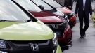 A man walks past Honda cars on display at Honda Motor Co. headquarters in Tokyo on April 28, 2017. (Koji Sasahara/AP) 