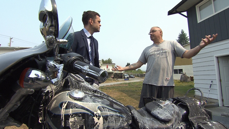 Rob Supeene, right, speaks to CTV News' David Molko after his Harley-David motorcycle was vandalized in Coquitlam. 