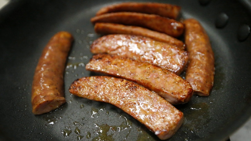 In this March 21, 2017 file photo, a sample of wild boar sausage simmers in a frying pan in Springfield, La. (AP Photo / Gerald Herbert)